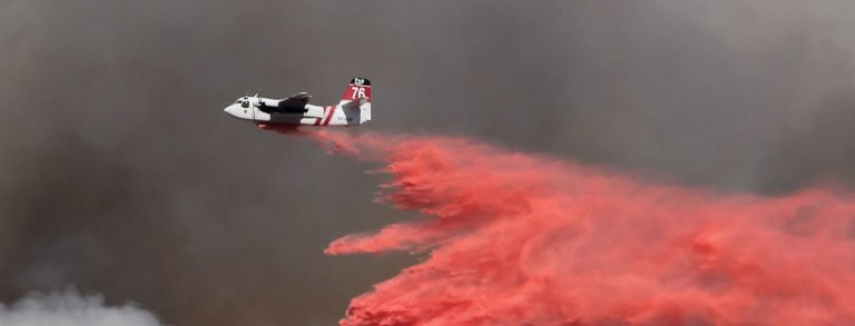 plane dropping fire retardant