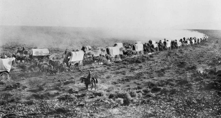 Train of covered wagons on the Santa Fe Trail
