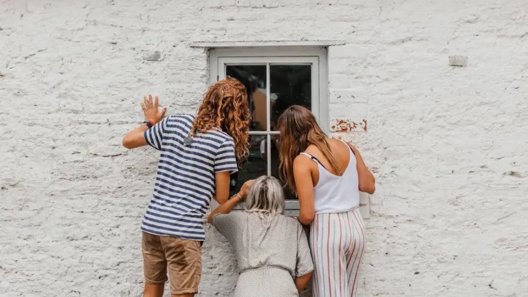 3 Women peeking in a window